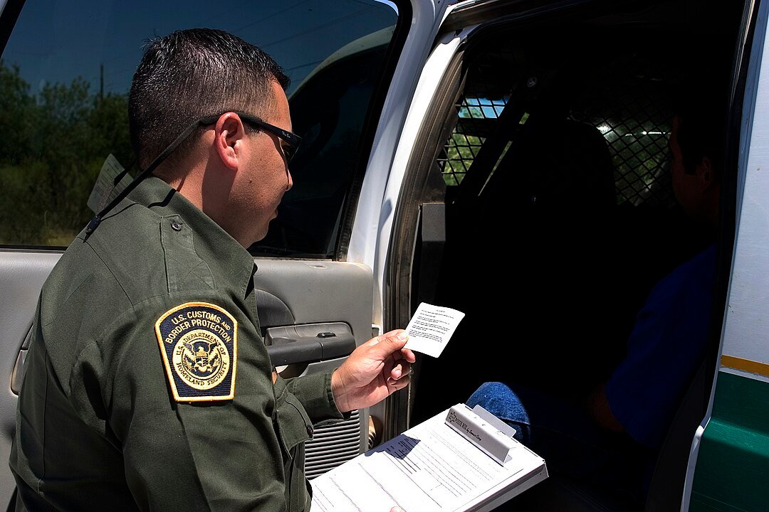 A U.S. Customs and Border Protection (CBP) Border Patrol agent reading the Miranda rights to a suspect