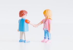 3 children in white and blue shirts