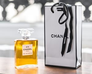 a bottle of chanel on a table next to a bag