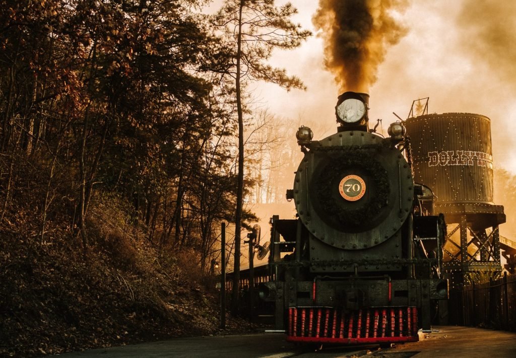 a steam engine train traveling down train tracks