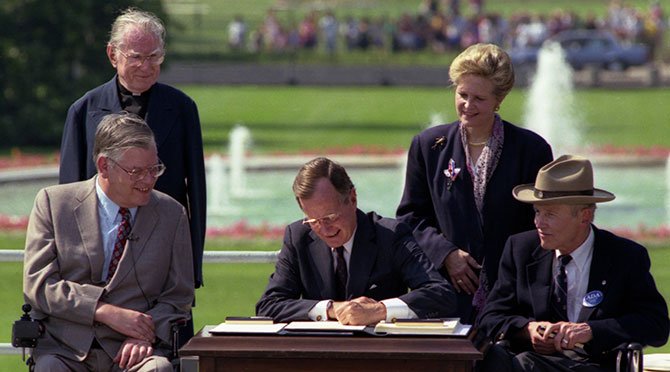 President George H. W. Bush Signs the Americans with Disabilities Act, 07/26/1990.