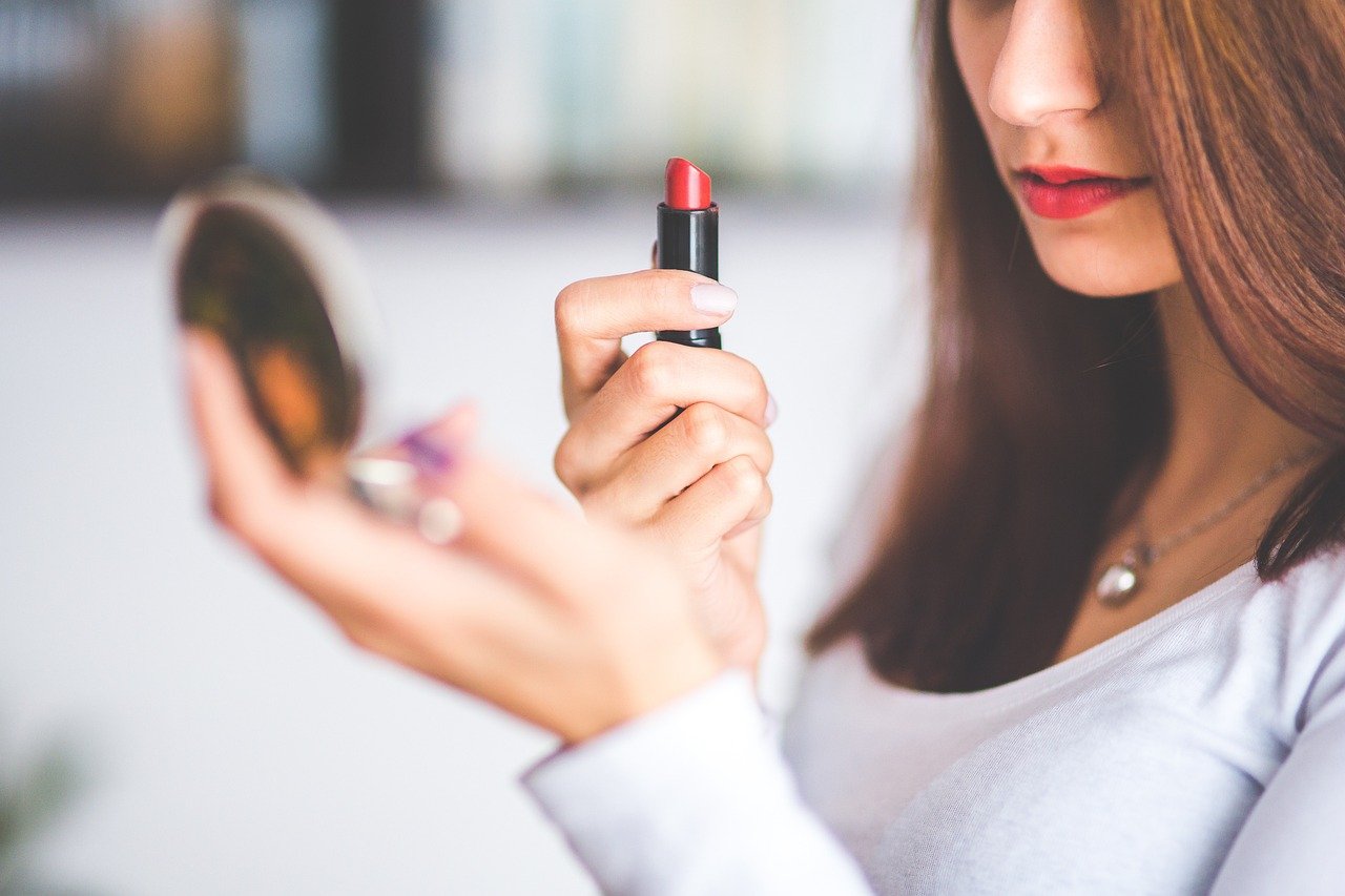 Woman using lipstick